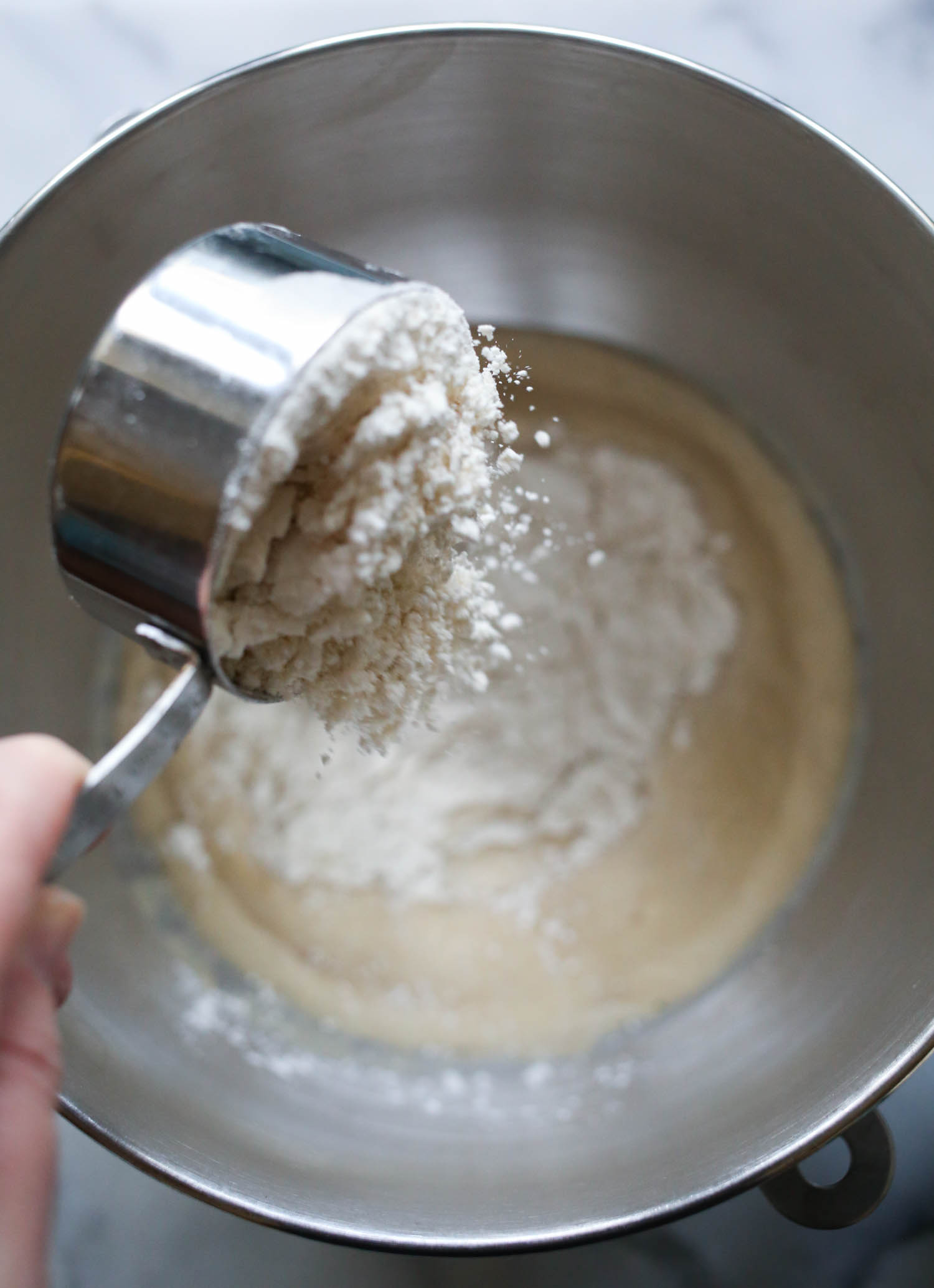 adding flour to breadsticks from our best bites