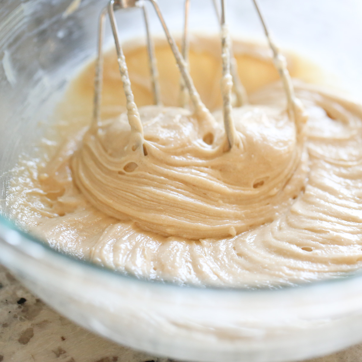 whipping caramel toffee dip ingredients in a mixing bowl