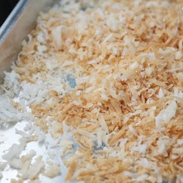 Shredded coconut, toasted on a sheet pan.