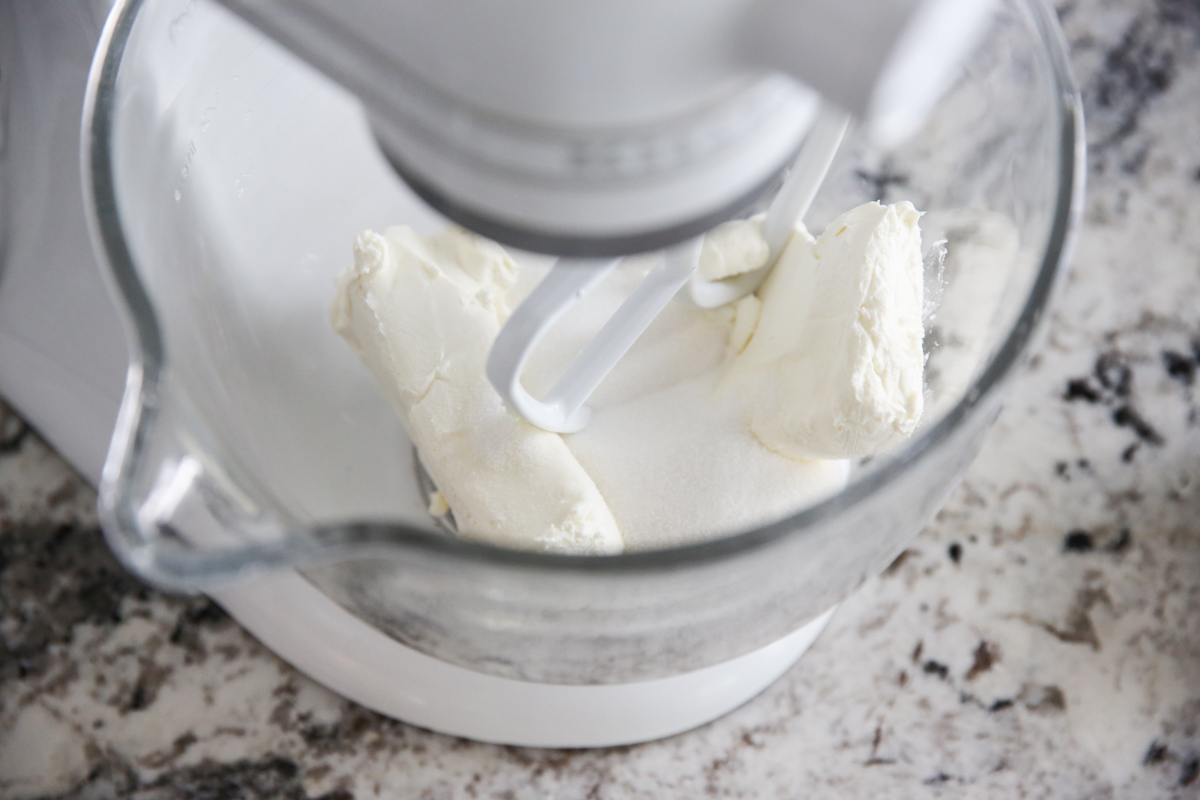 cheesecake batter mixing in a stand mixer