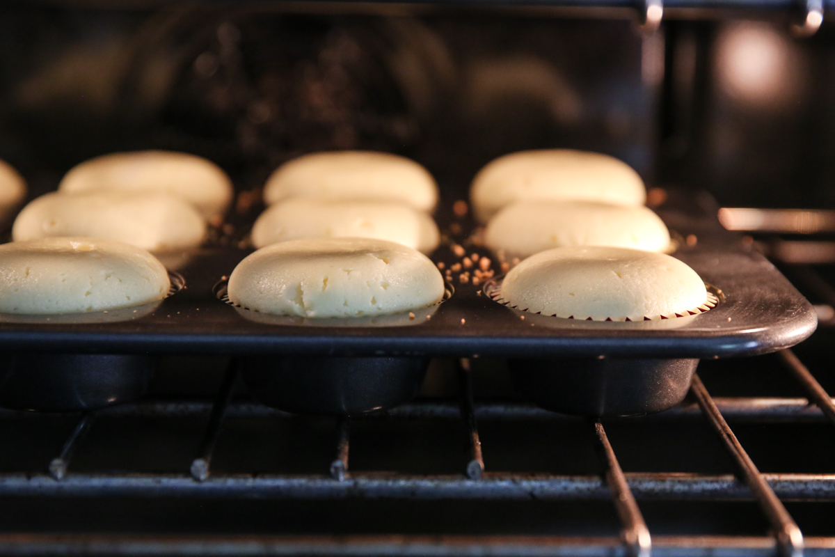 Cheesecakes baking in a muffin tin