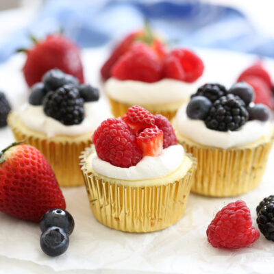 fruit topped mini cheesecakes on a platter