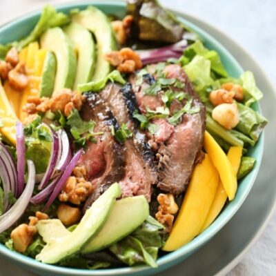 Steak and mango salad in a big bowl