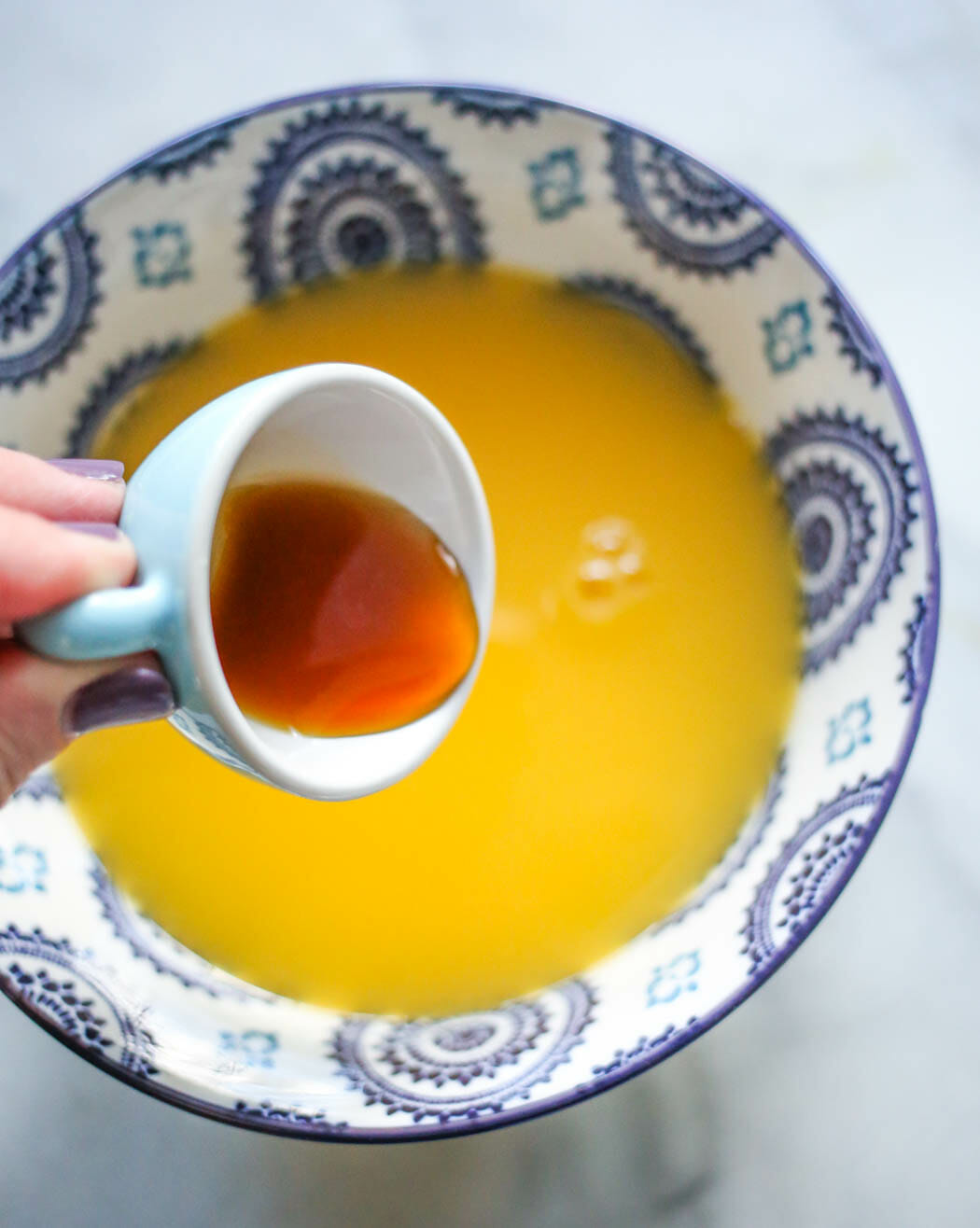 adding extracts to orange juice and sugar