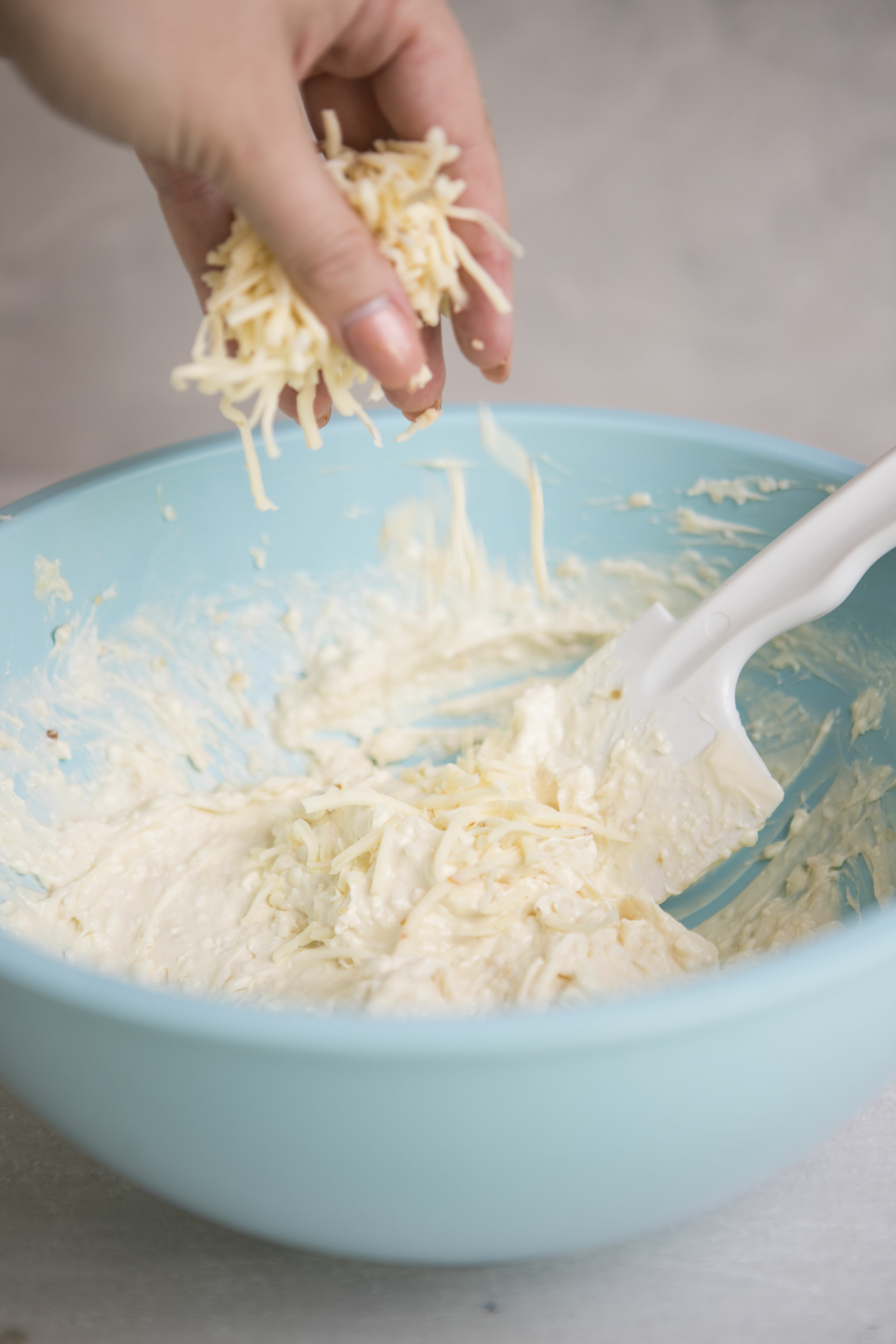 adding grated cheese