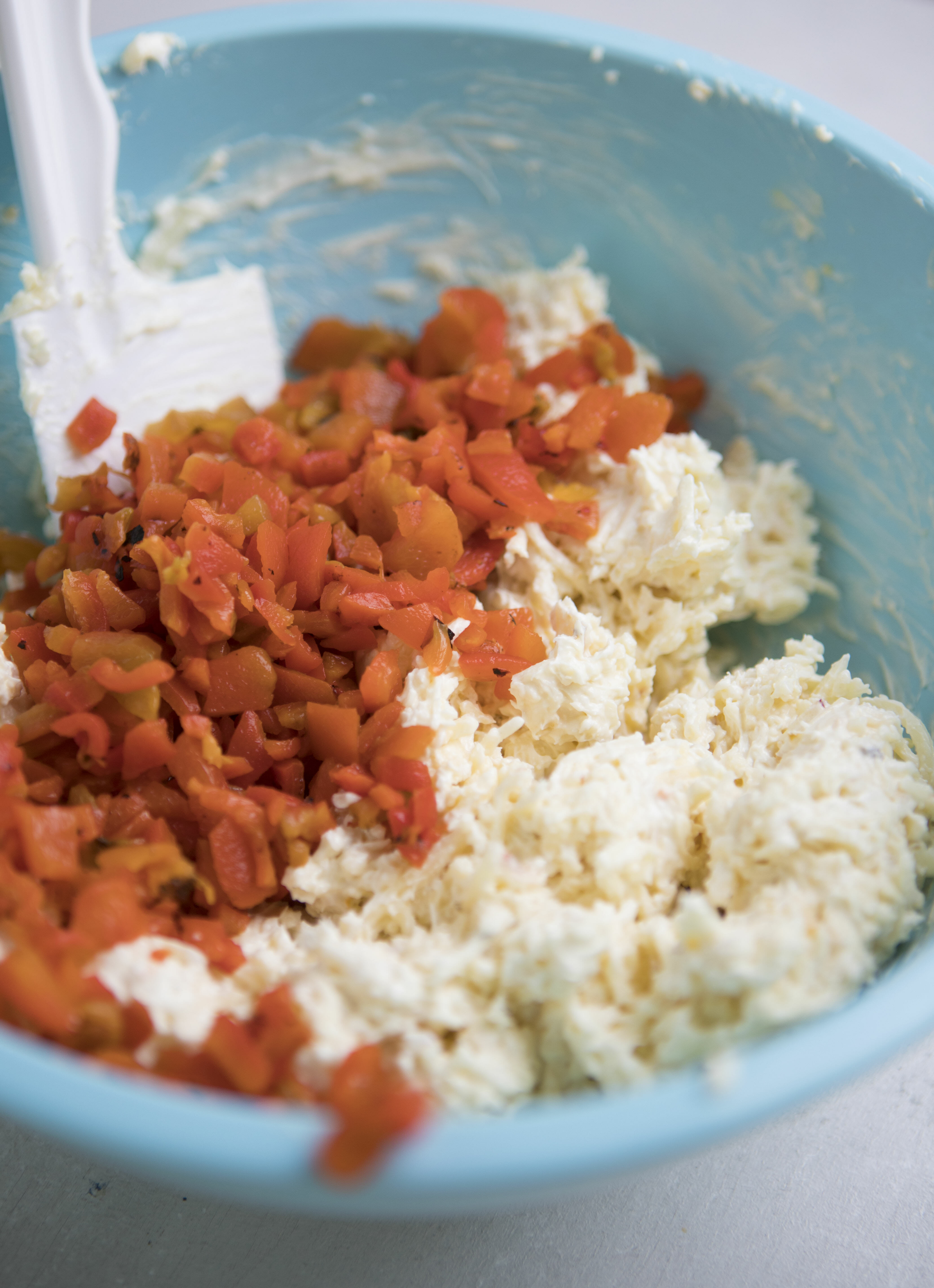 adding diced peppers to dip