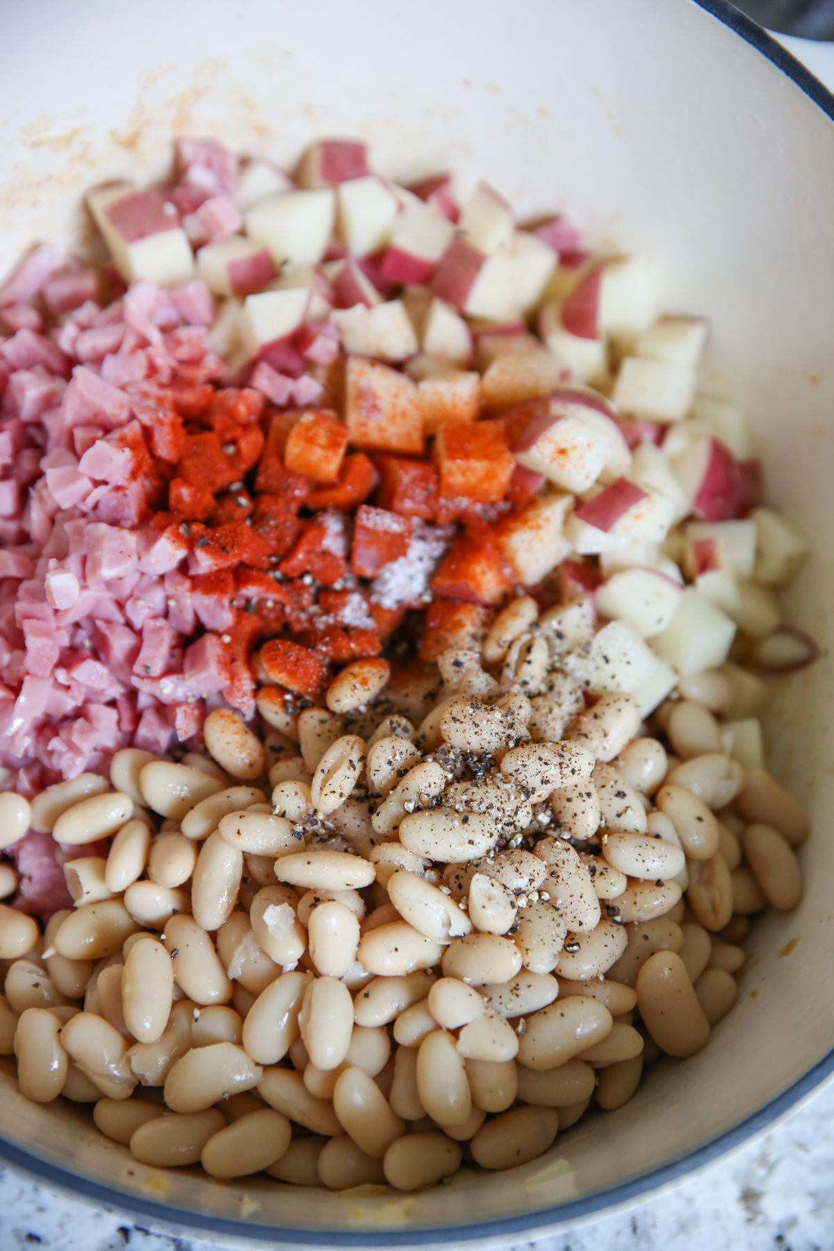 beans potatoes and onions in a soup pot