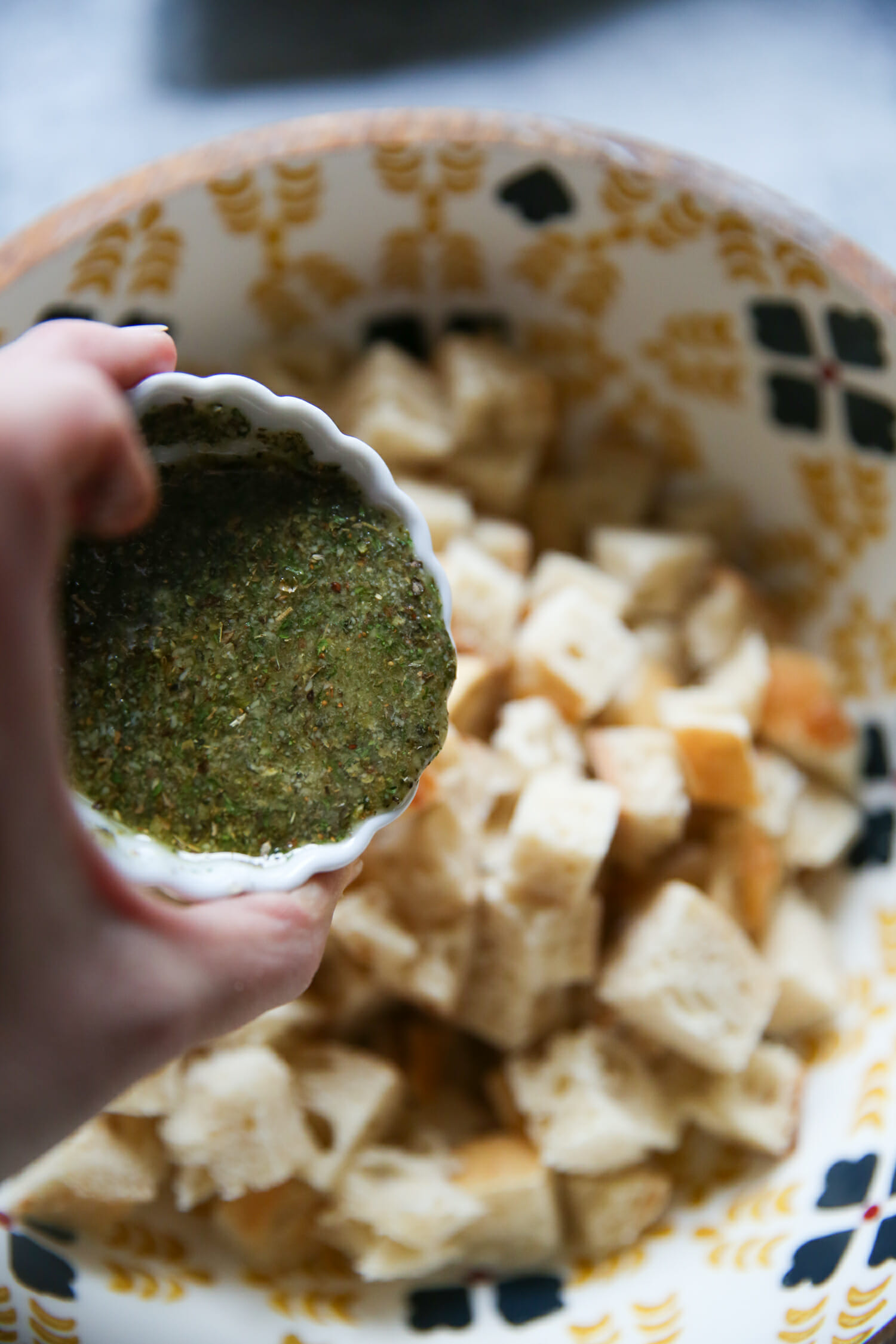 seasoning homemade sourdough garlic-herb croutons from our best bites
