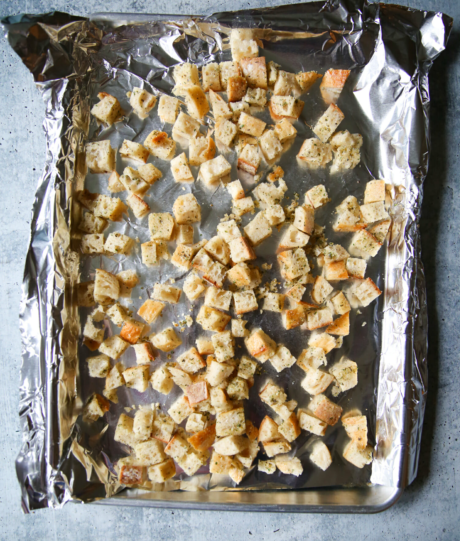 baking homemade sourdough garlic-herb croutons from our best bites