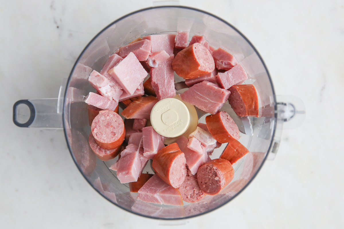 sausage and ham in a food processor