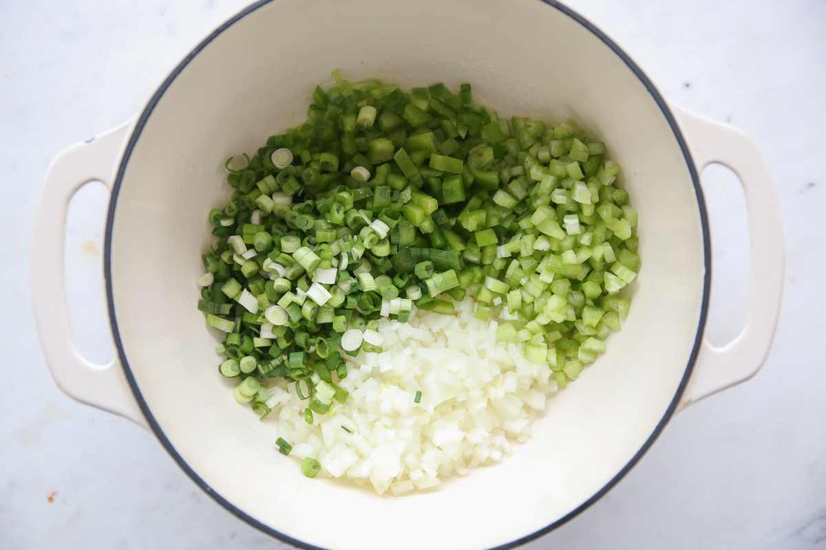 chopped celery, onion, bell pepper, and onions in a dutch oven