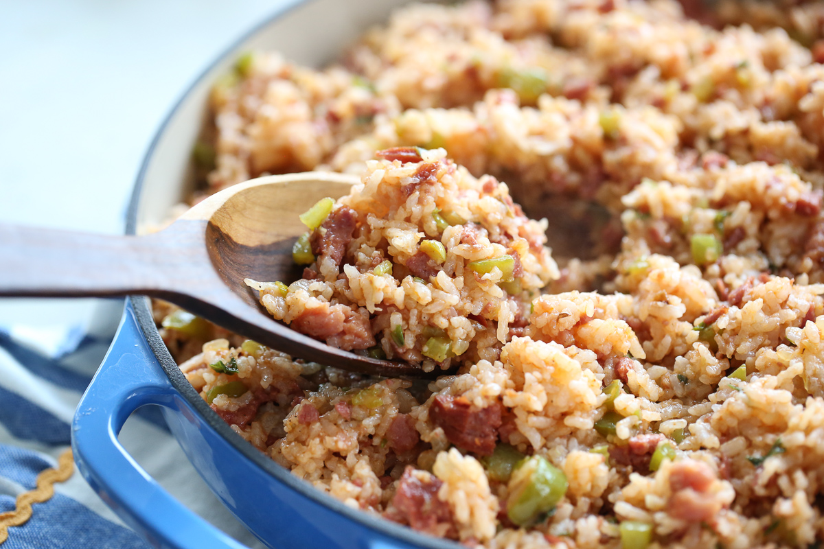 close up of a wooden spoon serving up jambalaya 