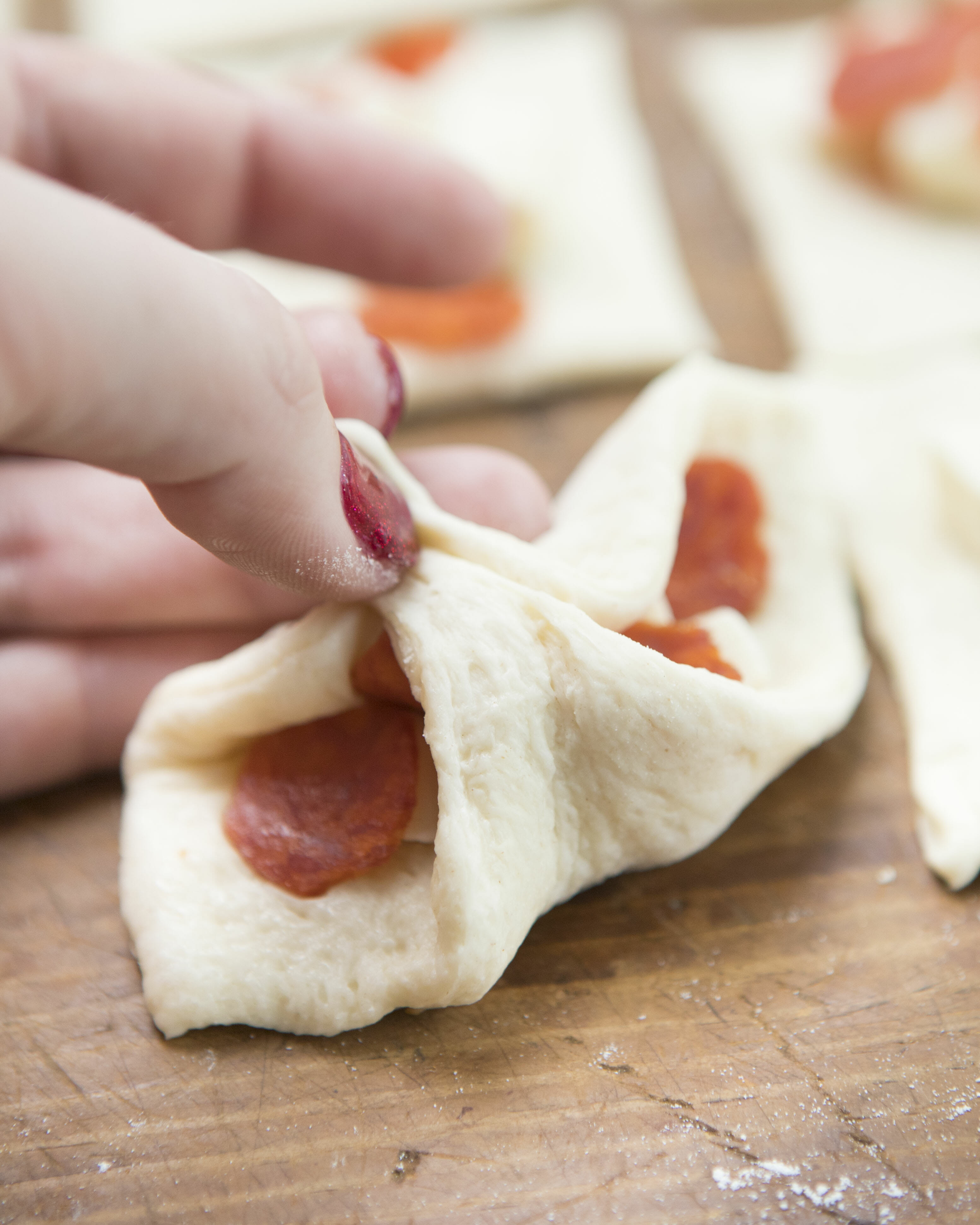 folding stuffed pizza rolls