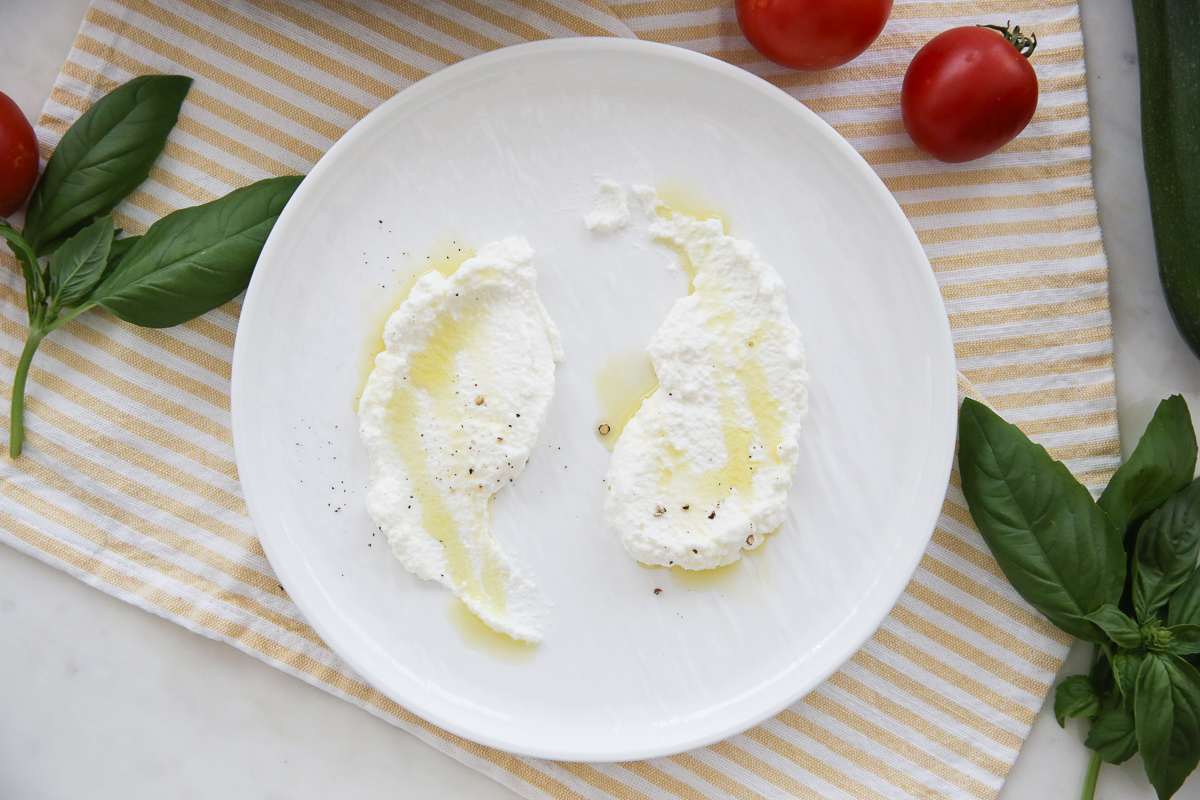 Ricotta on a plate with olive oil and pepper