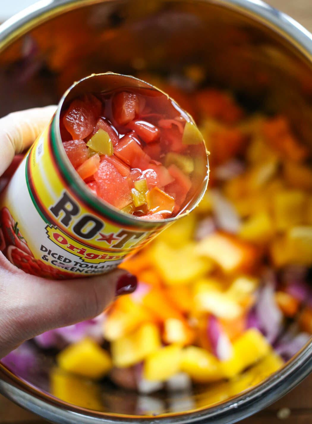 adding canned tomatoes to southwestern beef wraps