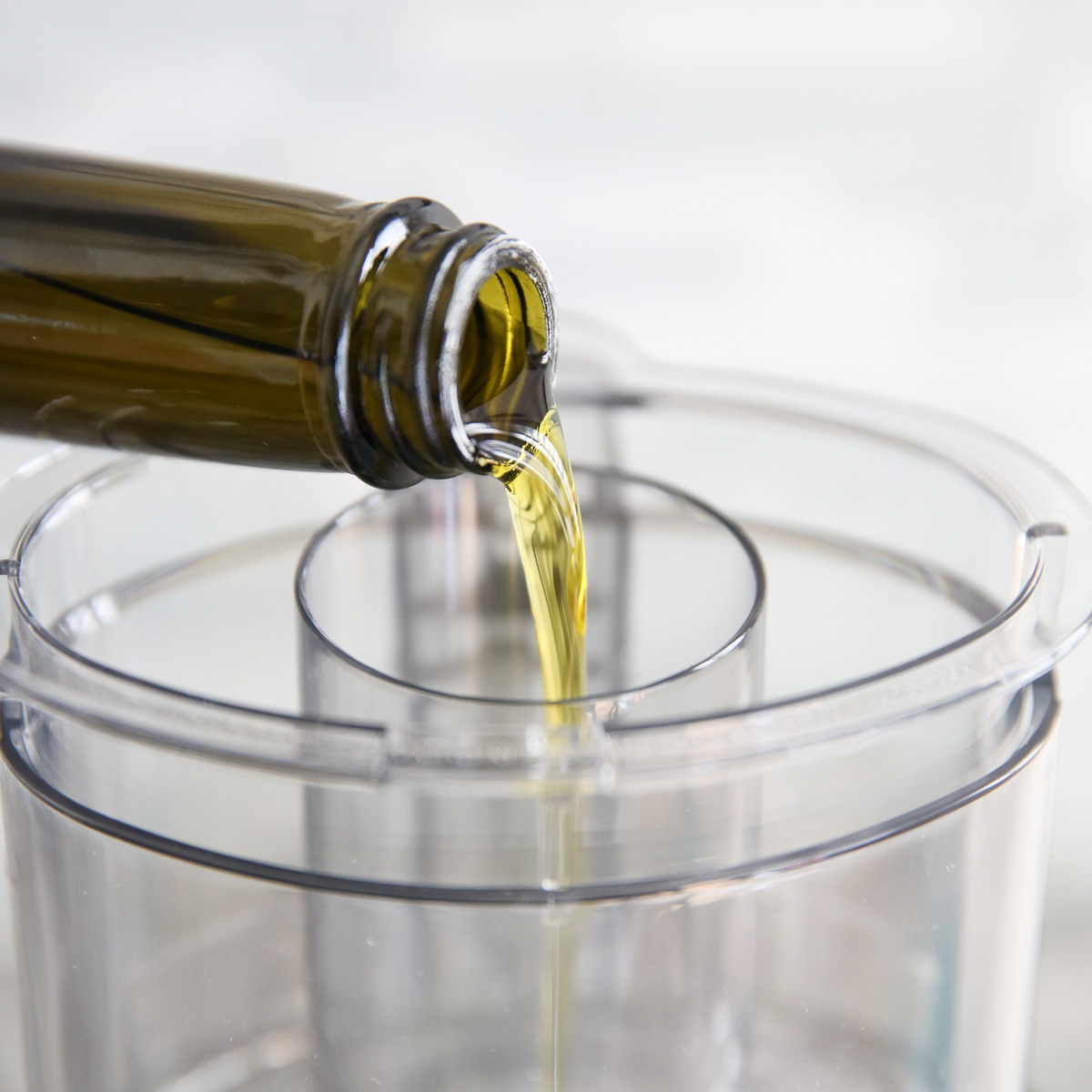 pouring oil in food processor