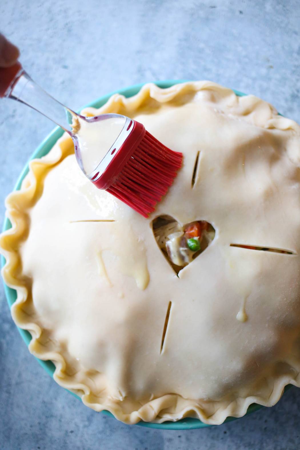 brushing egg on chicken pot pie crust