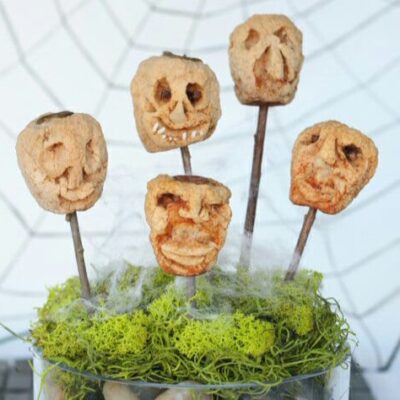 A collection of "shrunken heads" made of dried apples on sticks.