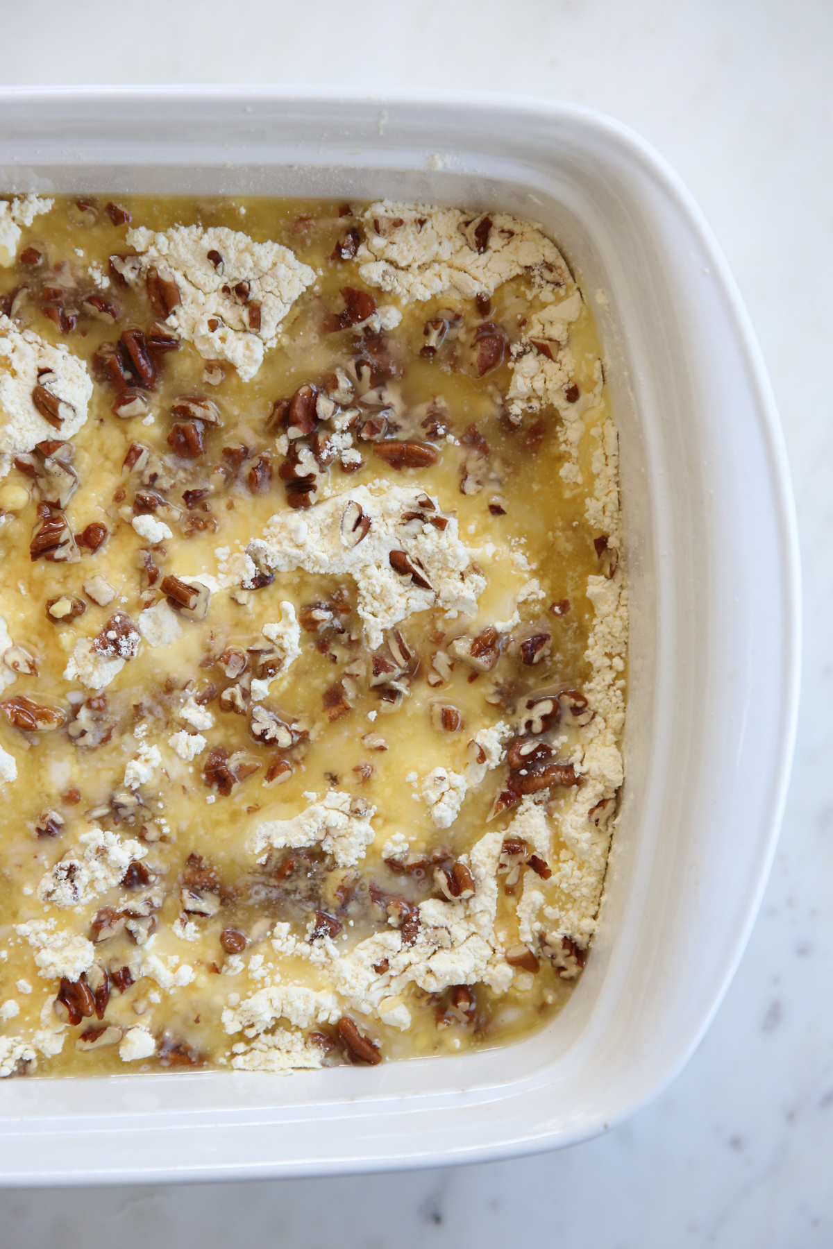 Melted butter on dump cake ready to bake