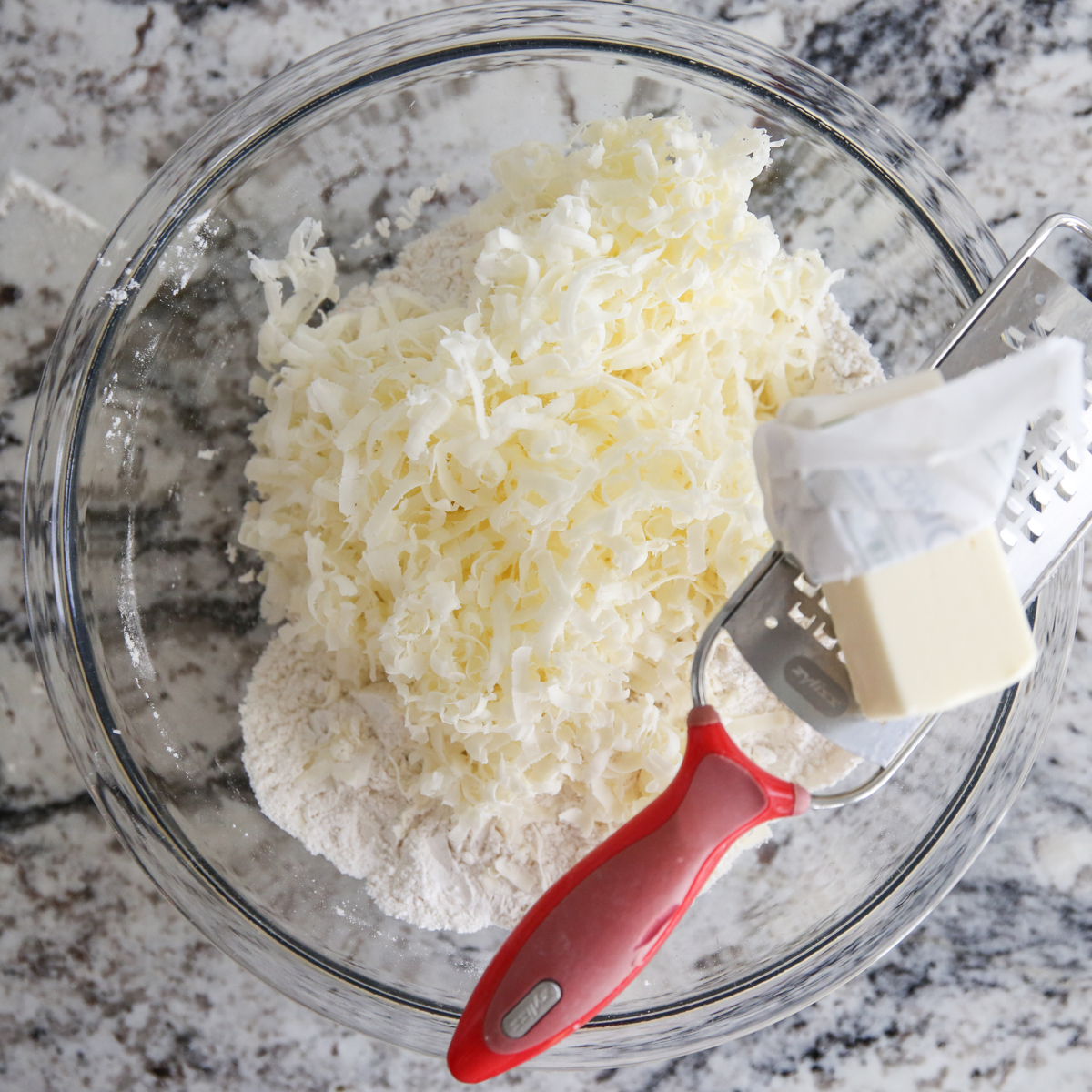 grating butter into biscuit dough