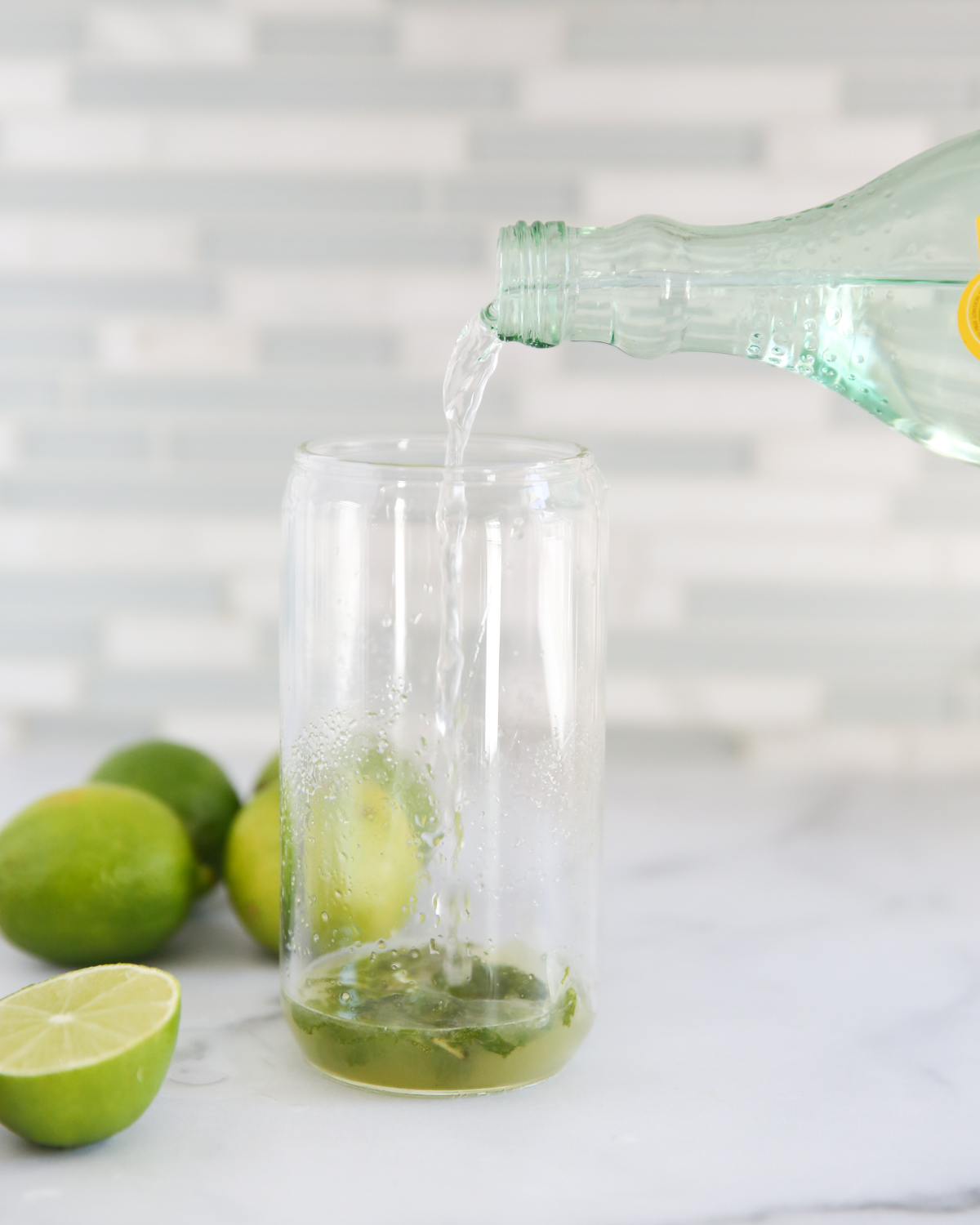 pouring sparkling water in a glass
