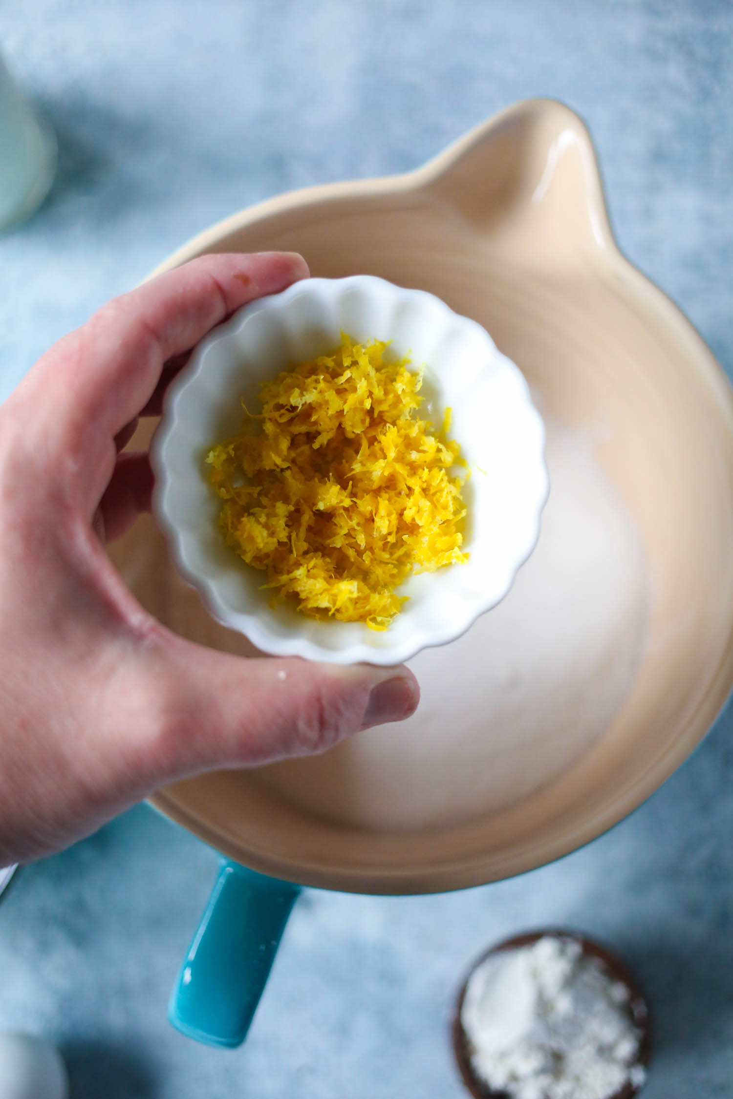 adding lemon peel to flour for streusel topped blueberry muffins from our best bites