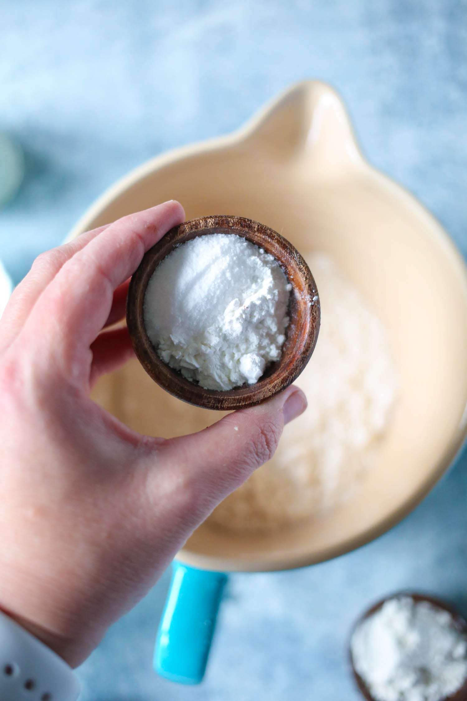 adding baking soda and salt to flour for streusel topped blueberry muffins from our best bites