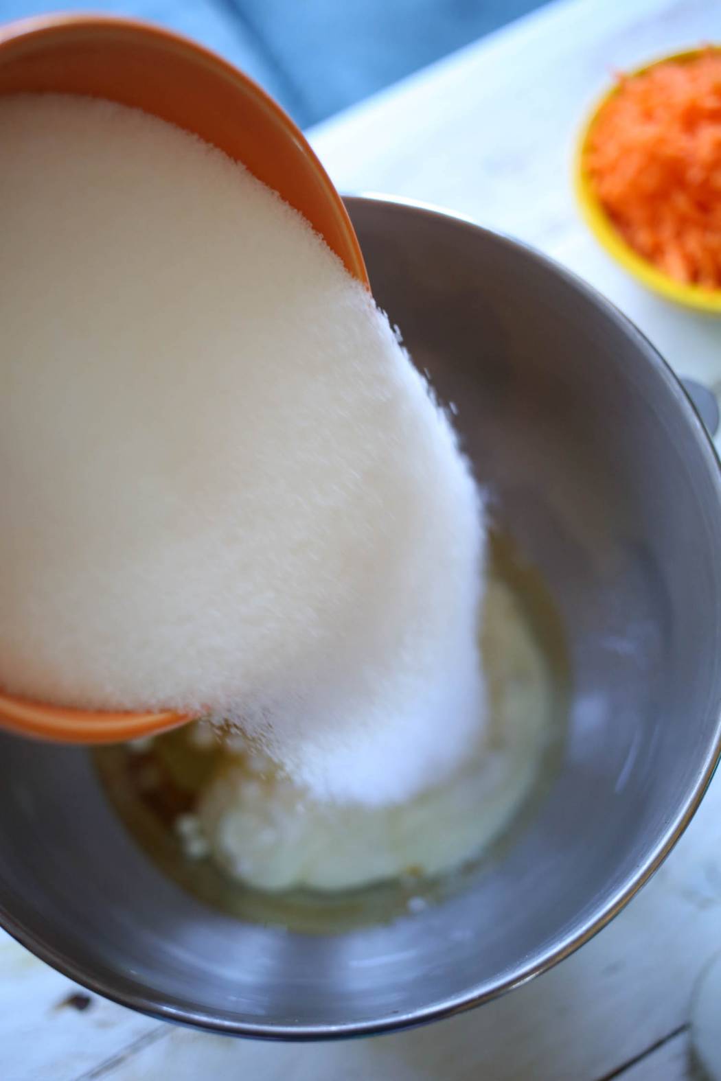 adding sugar to carrot cake