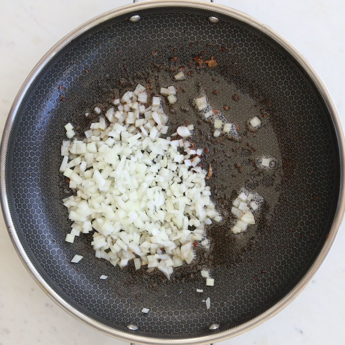 cooking onions in a skillet