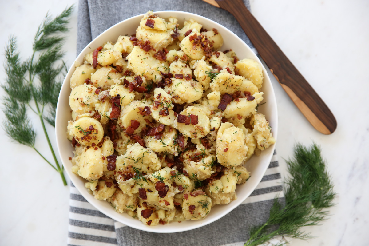 German potato salad in a white serving bowl