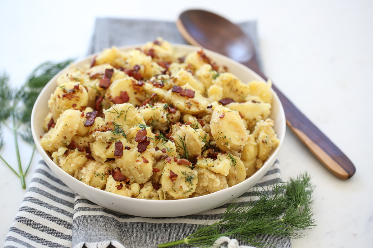 German potato salad in a white serving bowl