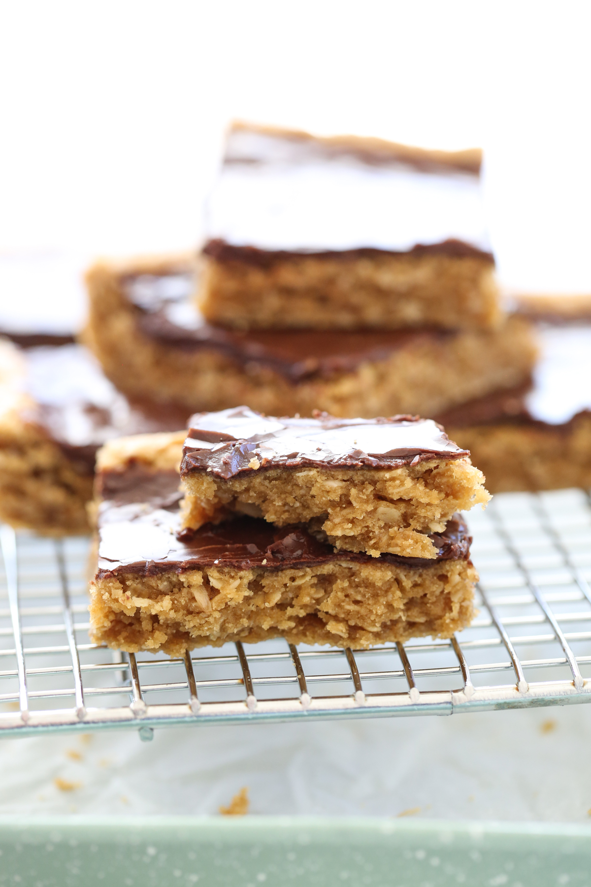 stacked peanut butter cookie bars on a cooling rack