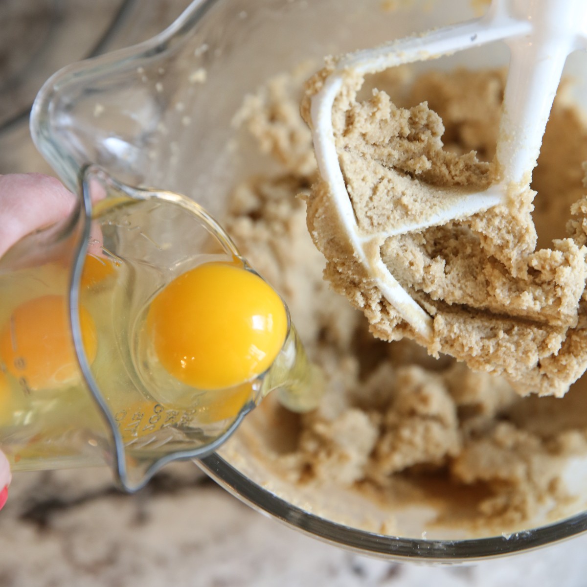adding egg to dough