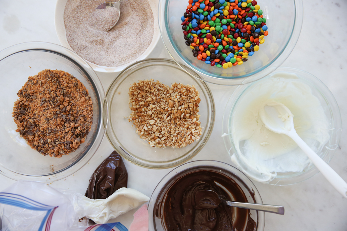caramel apple toppings in bowls