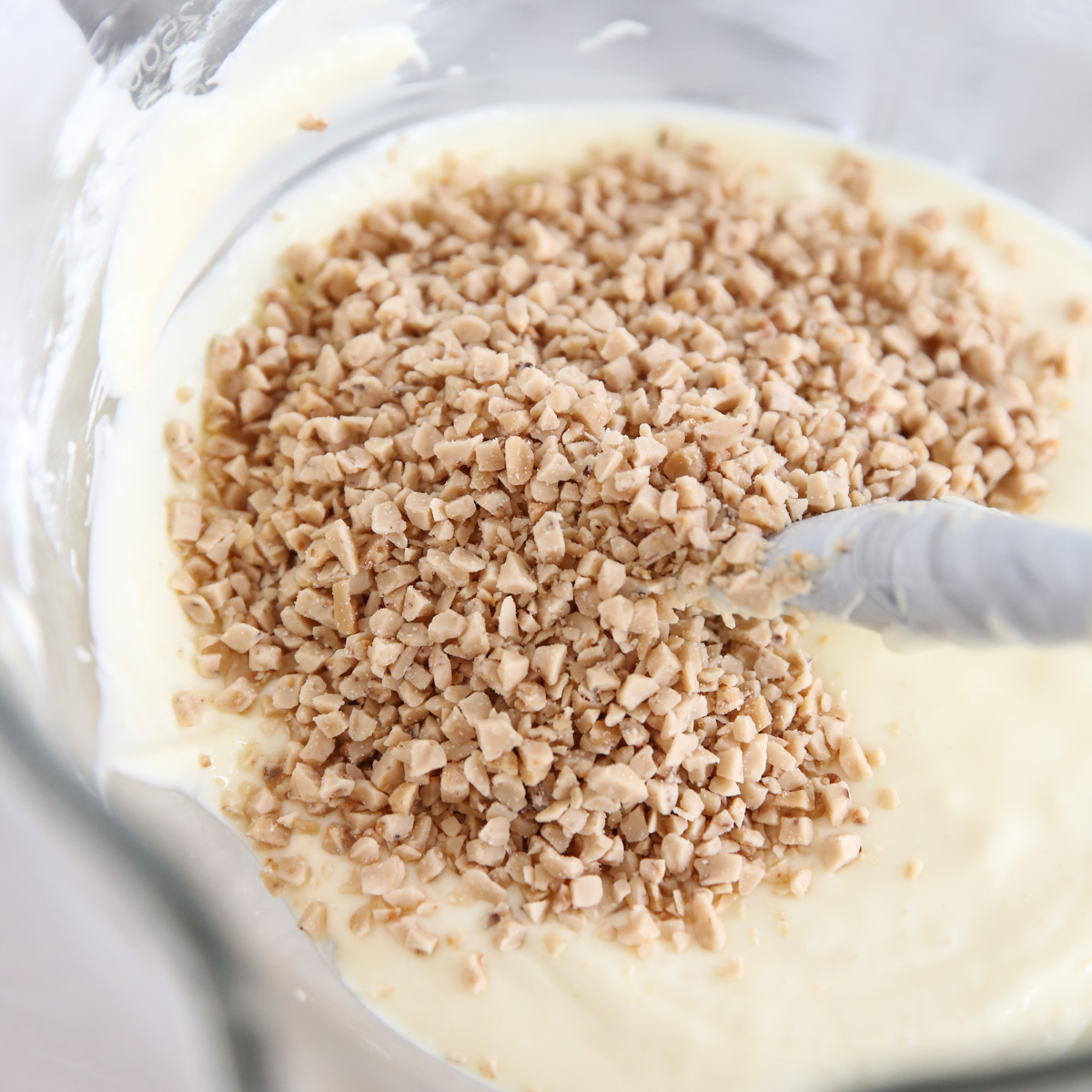 stirring heath chips into cheesecake batter