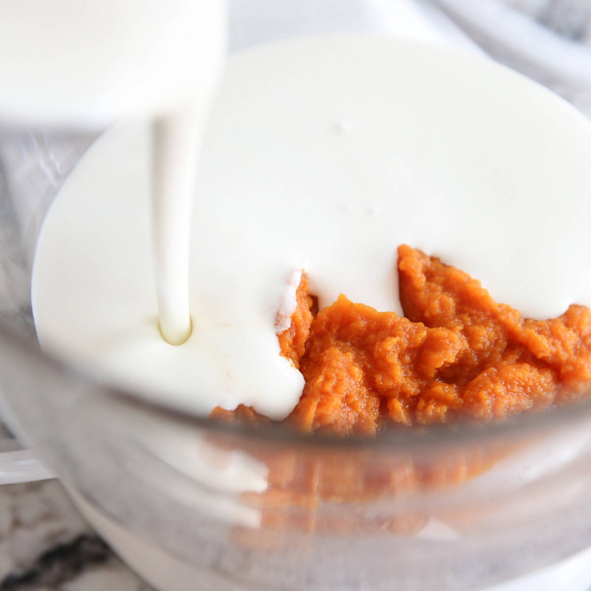 layered cheesecake ingredients in a mixing bowl