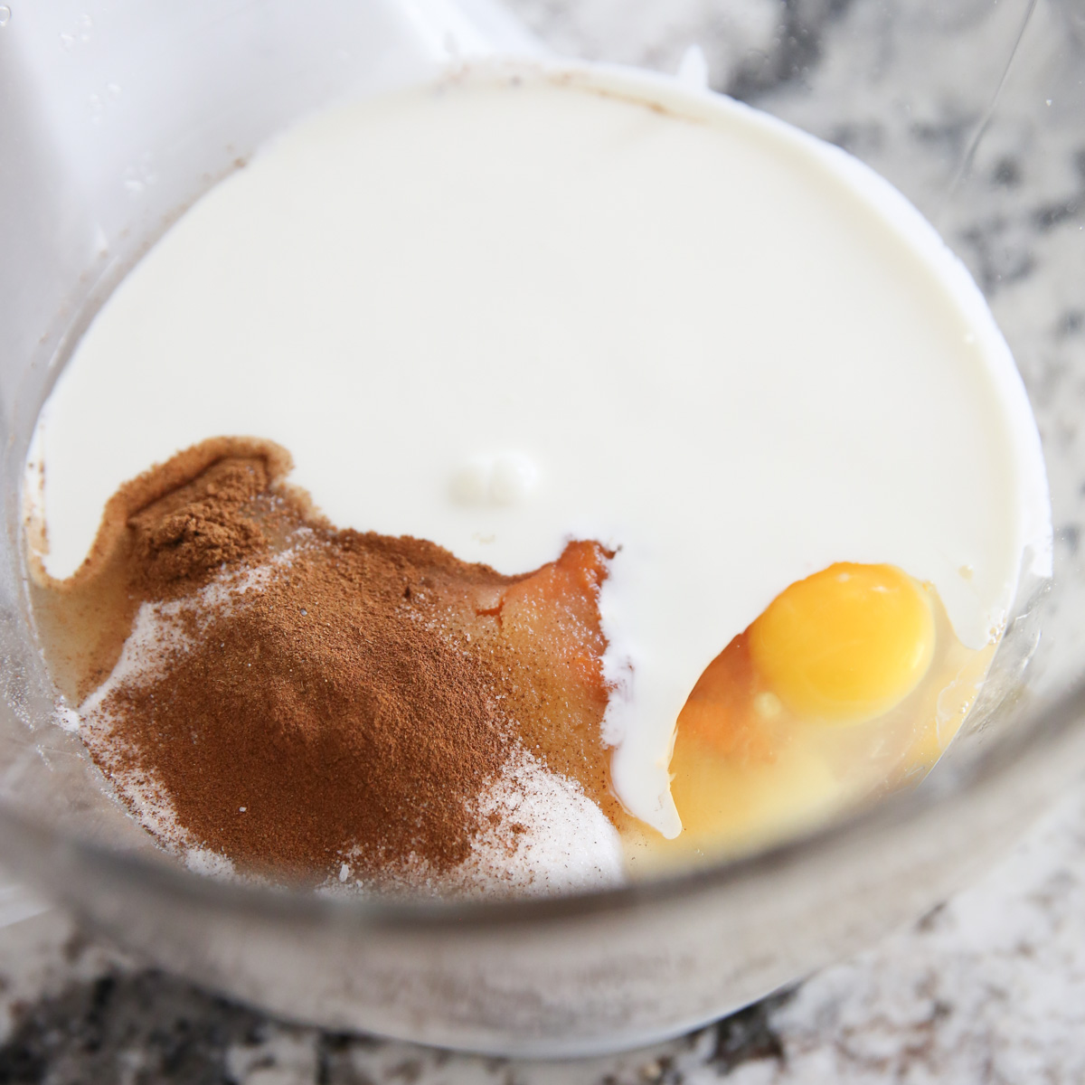 layered cheesecake ingredients in a mixing bowl