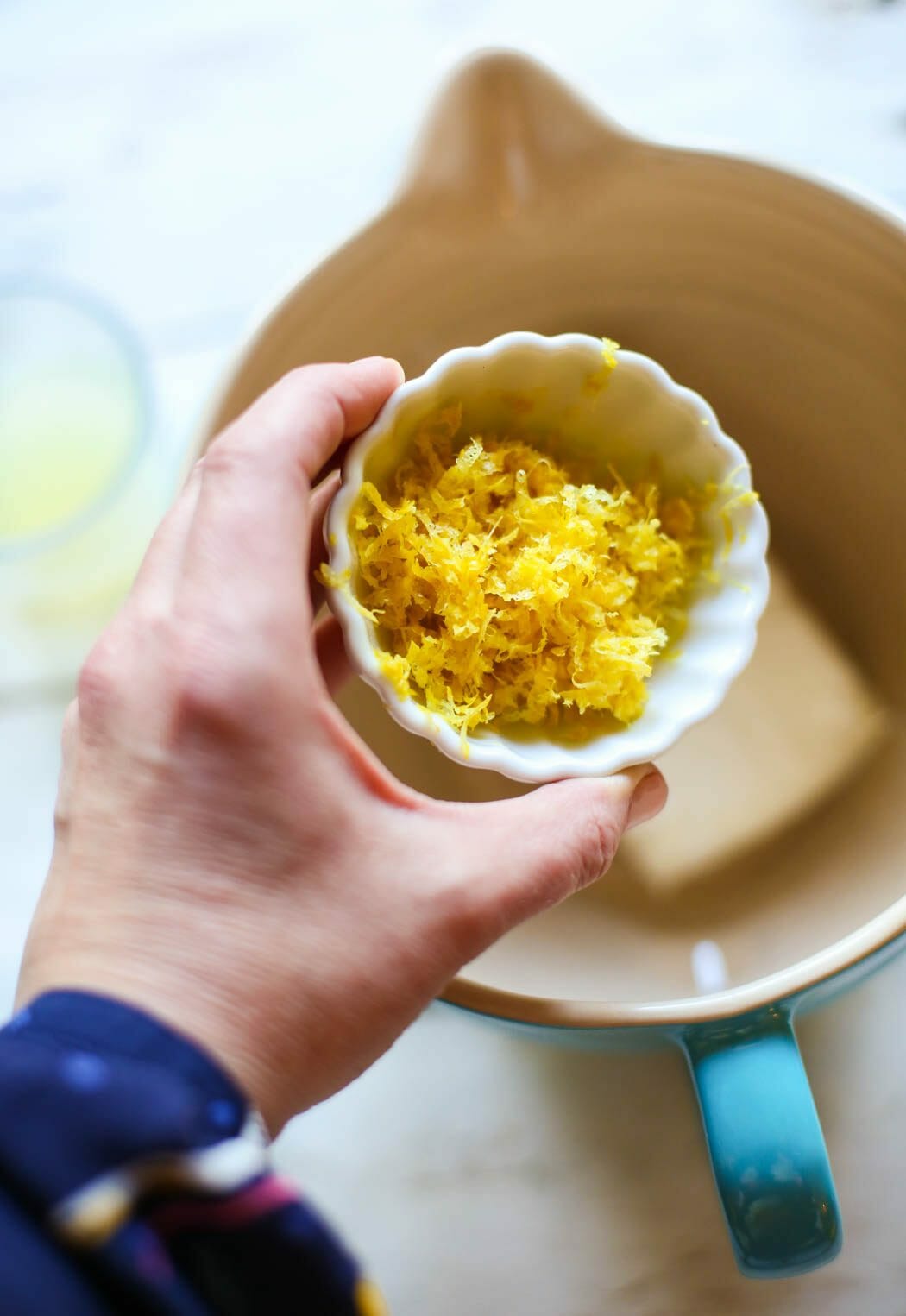 adding lemon zest to Overnight Cream Cheese Stuffed Lemon French Toast with Strawberries