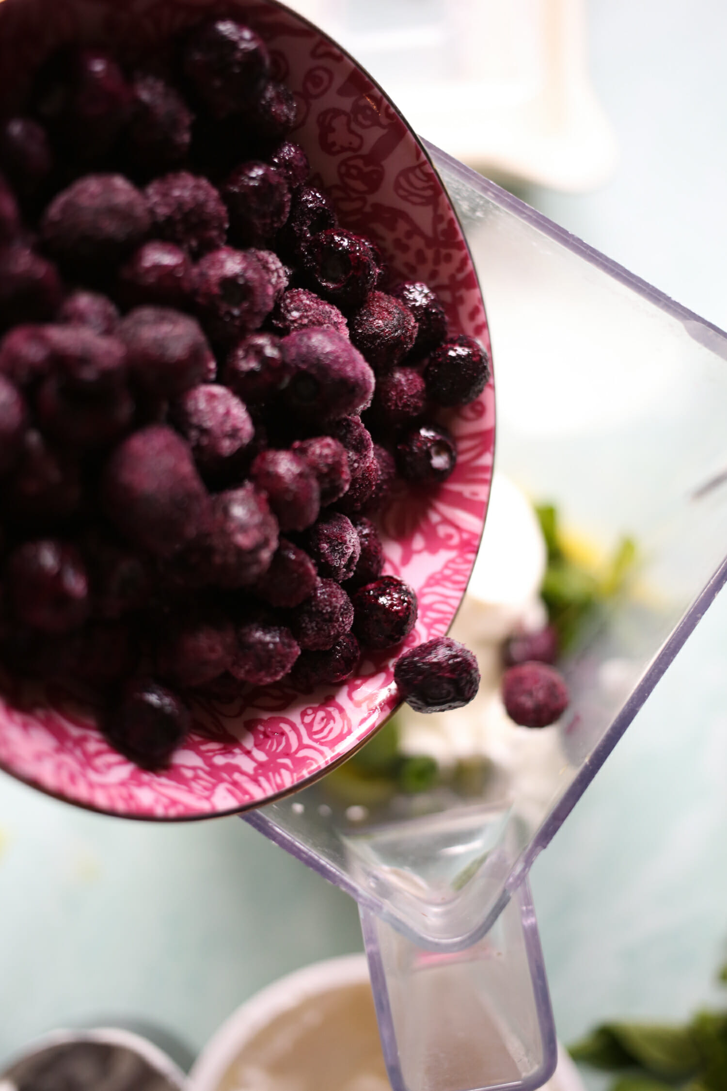 adding blueberries to smoothie