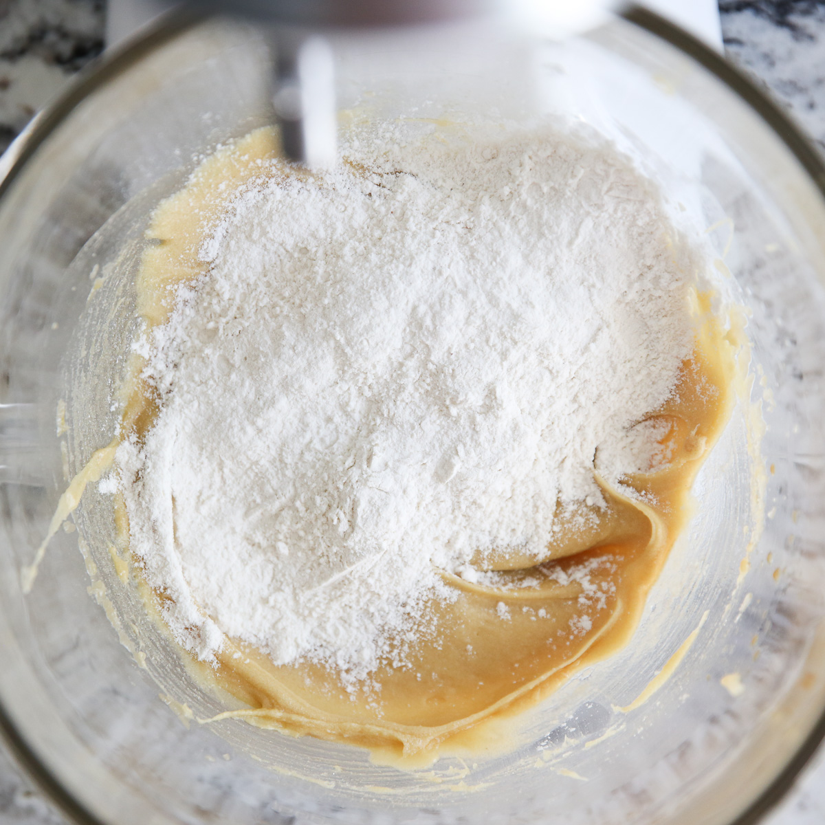 adding dry ingredients to cookie dough