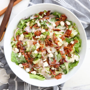 green salad in a white serving bowl