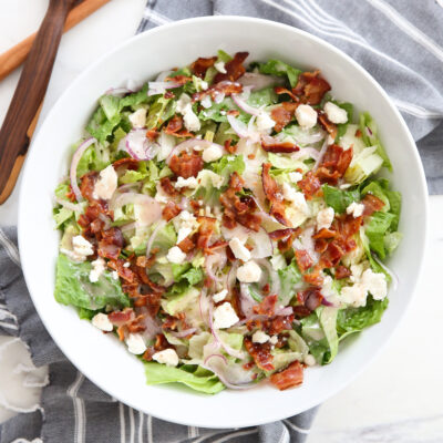 green salad in a white serving bowl