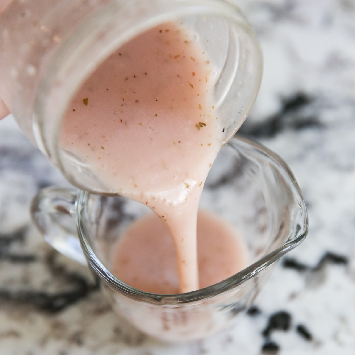 pouring dressing into a container