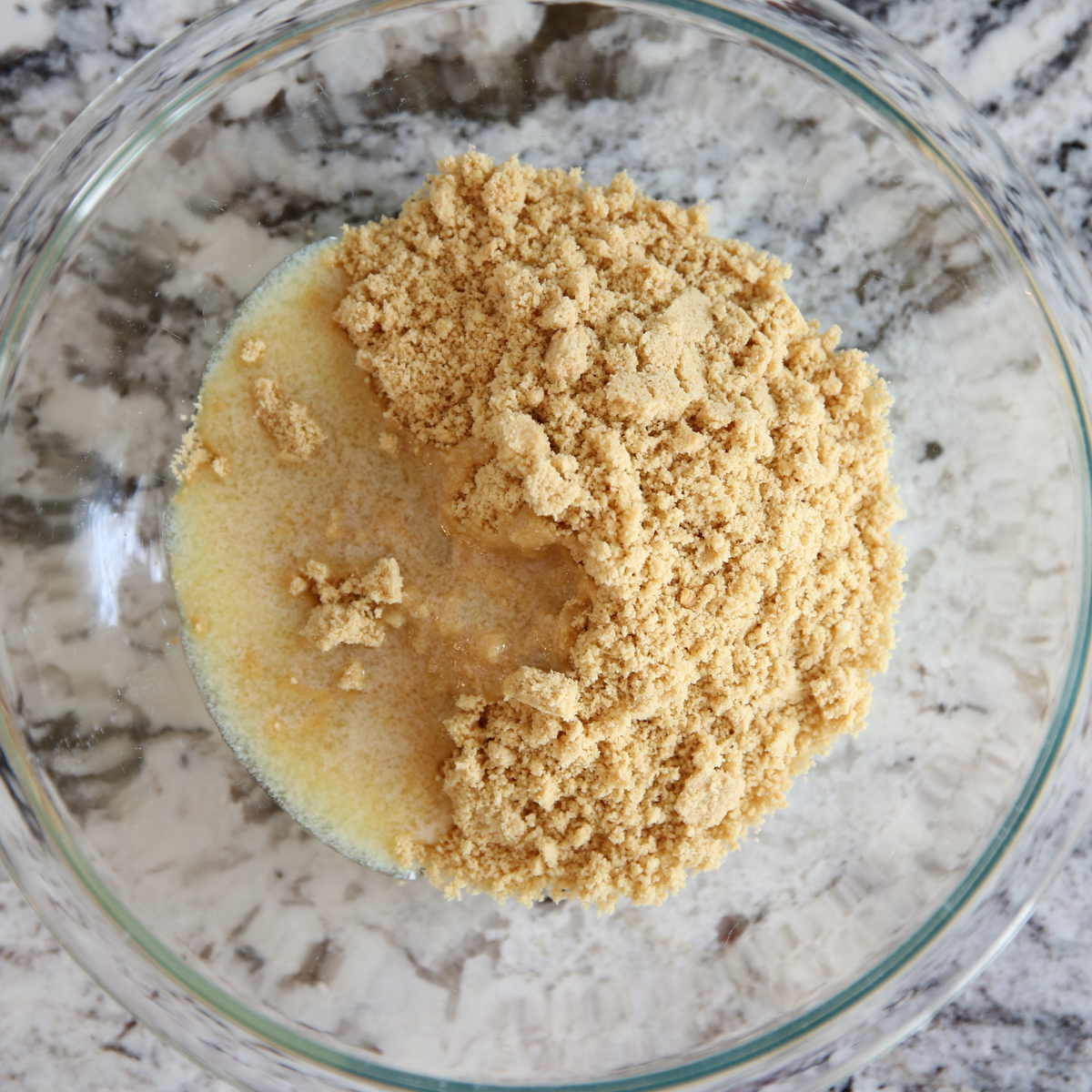 cookie crumbs and butter in a bowl