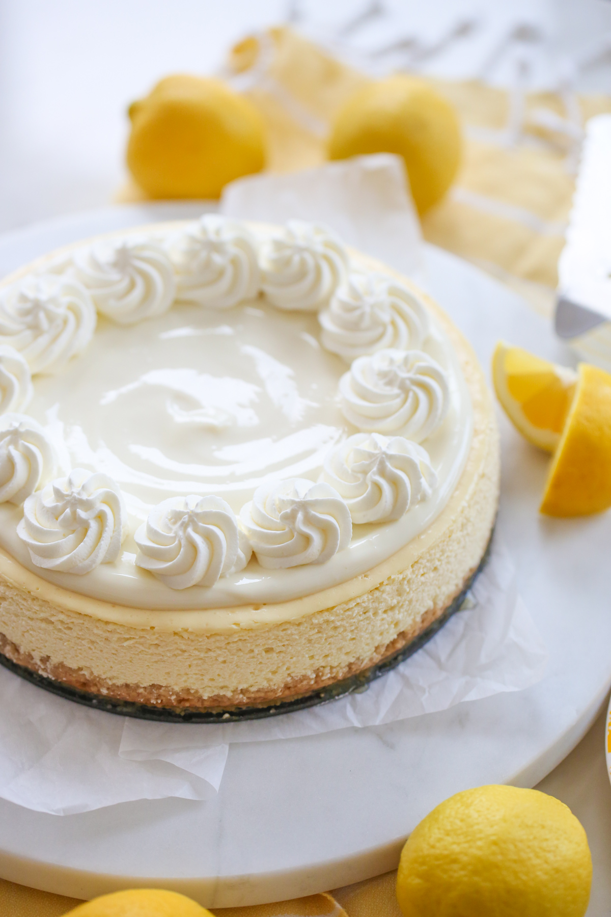 cooked lemon cheesecake with fresh lemons
