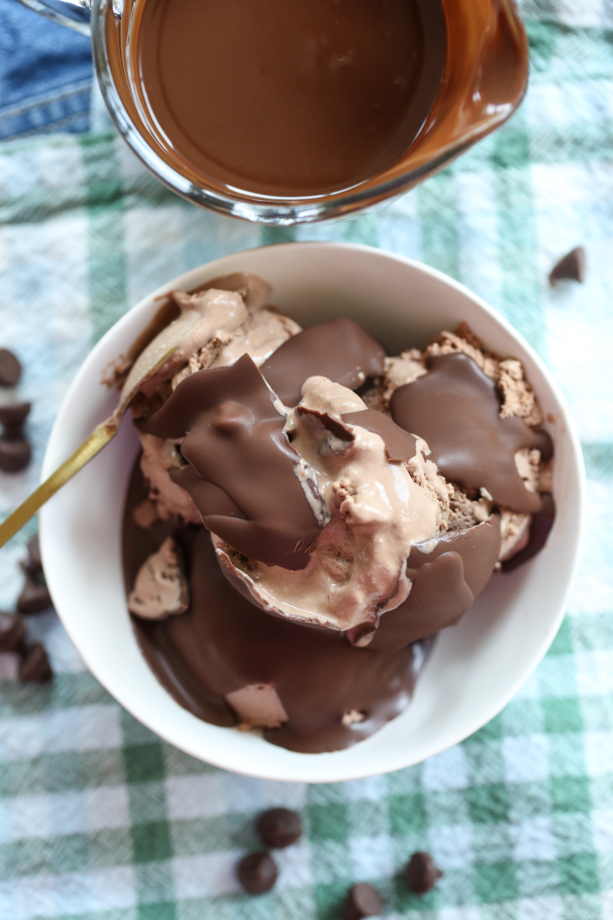 cracking homemade magic shell over ice cream