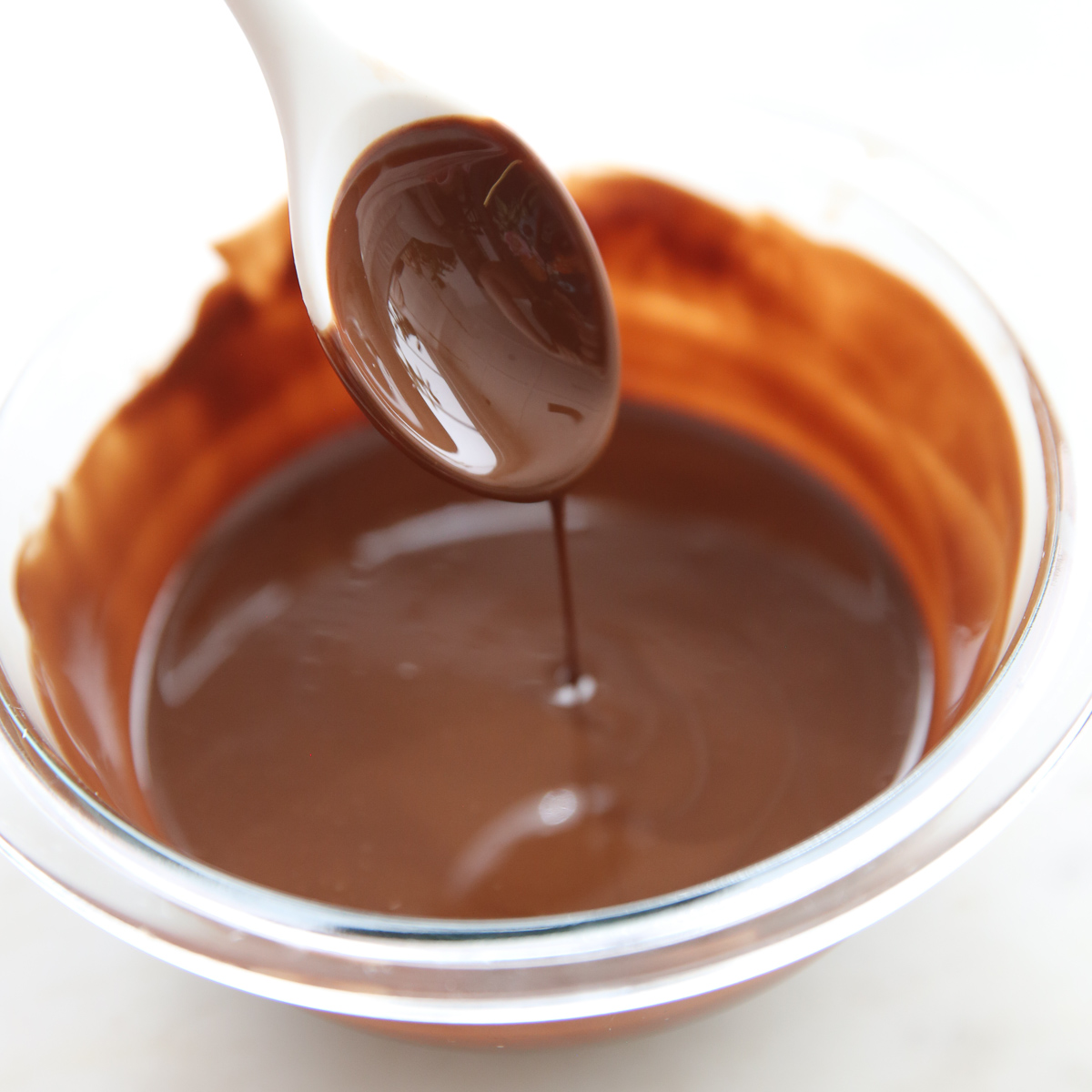 our best bites melted coconut oil and chocolate chips for magic shell topping