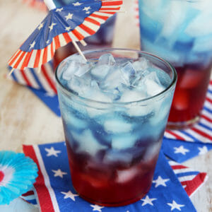 4th of July punch layered in red, white, and blue juices and sodas