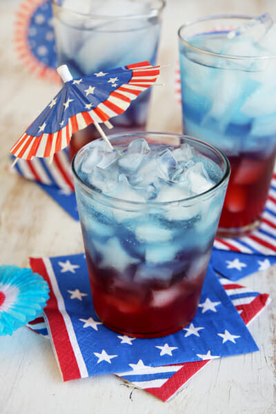 4th of July punch layered in red, white, and blue juices and sodas