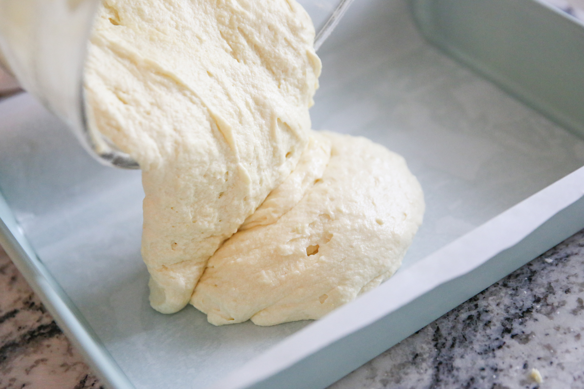 pouring cake batter in a pan